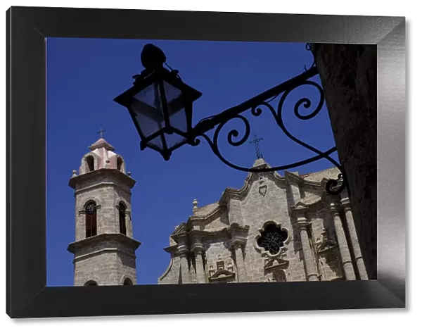 Historic church behind the silhouette of an iron lantern, Old Havana, Cuba, West Indies