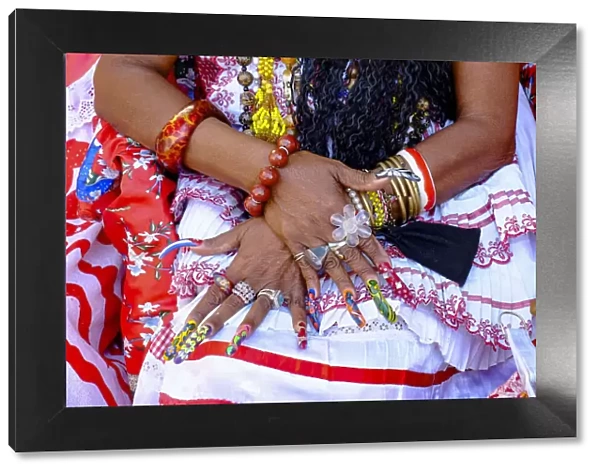 Colorful nails on the crossed hands of a lady in traditional dress, Old Havana, Cuba