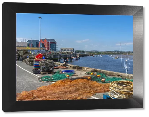 View of fishing nets on quayside and River Coquet at Amble, Morpeth, Northumberland