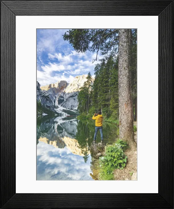 Framed Print : Hiker man photographing Lake Braies (Pragser Wildsee) with smartphone at sunrise Framed Print : Hiker man photographing Lake Braies (Pragser Wildsee) with smartphone at sunrise