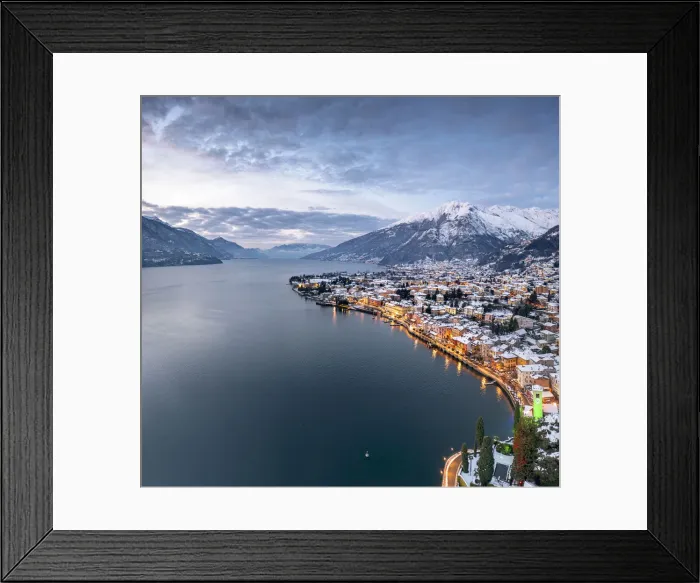 Framed Print : Winter sunrise over the illuminated lakeside town of Gravedona and snowy peaks, Lake Como Framed Print : Winter sunrise over the illuminated lakeside town of Gravedona and snowy peaks, Lake Como
