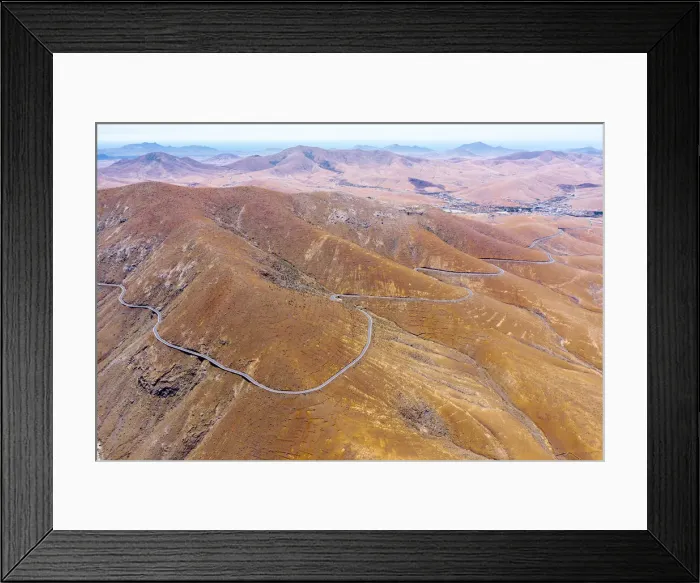 Framed Print : Aerial view of empty desert road, Mirador del Risco de las Penas viewpoint, Pajara Framed Print : Aerial view of empty desert road, Mirador del Risco de las Penas viewpoint, Pajara