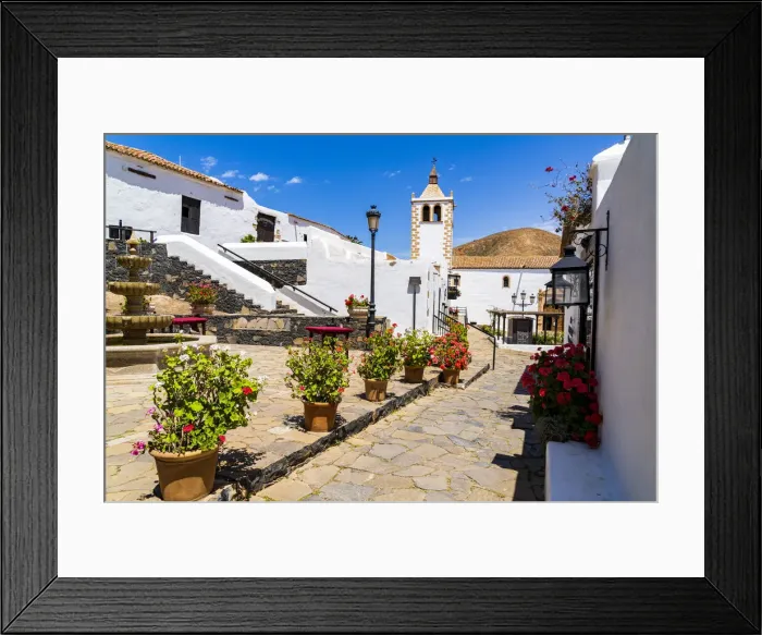 Framed Print : Colorful flowers framing Santa Maria cathedral church in the old town of Betancuria