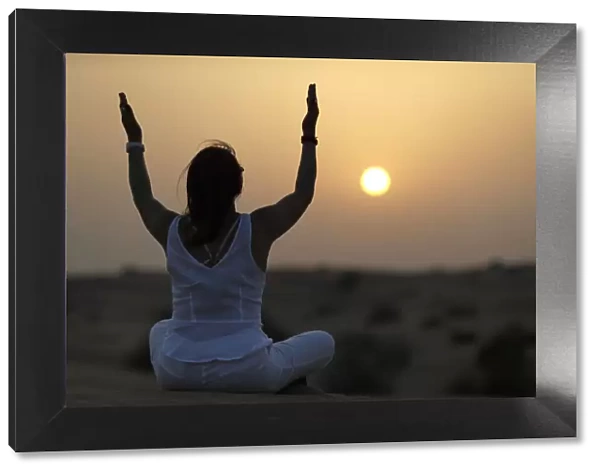 Sunset meditation in the desert at sunset, as concept for religion, faith