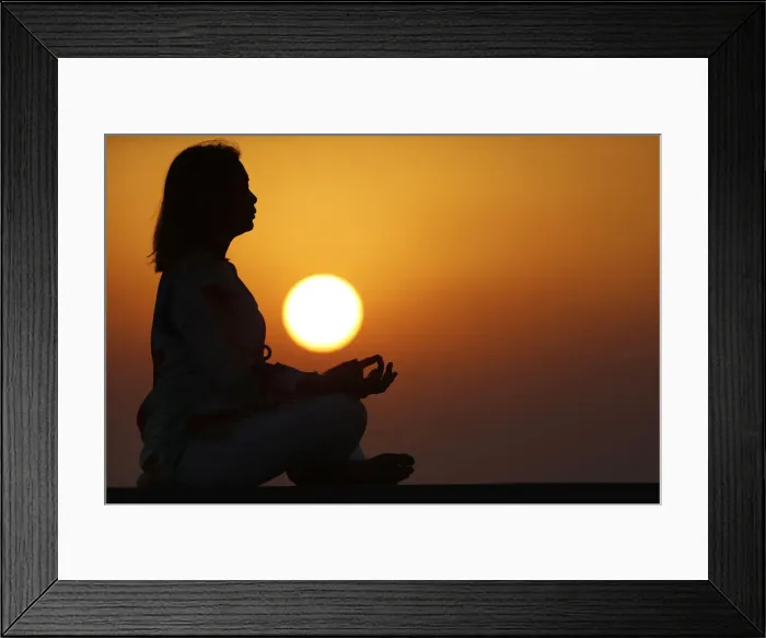 Framed Print : Woman practising yoga pose and meditation at sunset as concept for silence and relaxation Framed Print : Woman practising yoga pose and meditation at sunset as concept for silence and relaxation