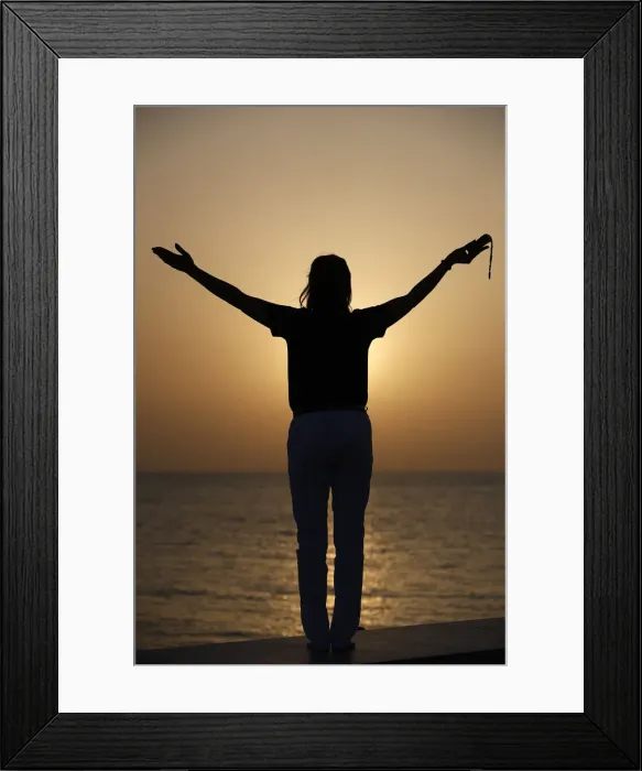 Framed Print : Silhouette of faithful woman praying with rosary beads at sunset as concept for religion Framed Print : Silhouette of faithful woman praying with rosary beads at sunset as concept for religion