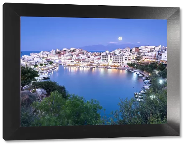 Moonlight over the old town of Agios Nikolaos and lake at dusk, Lasithi prefecture, Crete