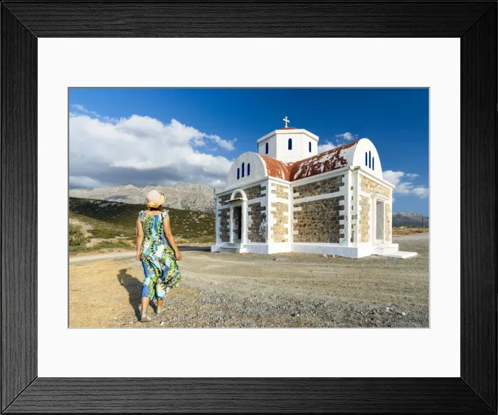 Framed Print : Rear view of woman in dress and straw hat walking to the Greek Orthodox church of Agia Framed Print : Rear view of woman in dress and straw hat walking to the Greek Orthodox church of Agia