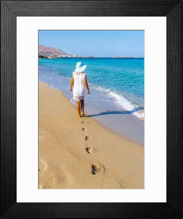 Framed Print : Young woman with sundress and hat walking on sand beach, Crete island, Greek Islands Framed Print : Young woman with sundress and hat walking on sand beach, Crete island, Greek Islands