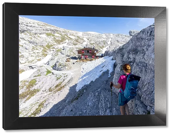 Woman enjoying the hike towards rifugio Pian di Cengia (Buellelejoch) hut in summer