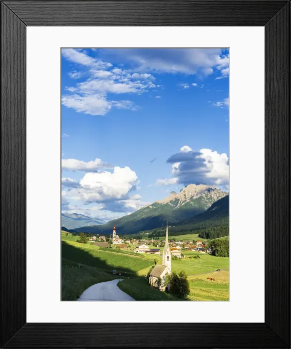 Framed Print : Sunshine over green pastures and village of Villabassa (Niederdorf) in summer Framed Print : Sunshine over green pastures and village of Villabassa (Niederdorf) in summer