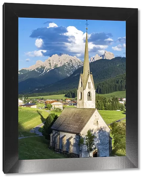 Church in the green landscape of alpine village of Villabassa (Niederdorf), Val Pusteria