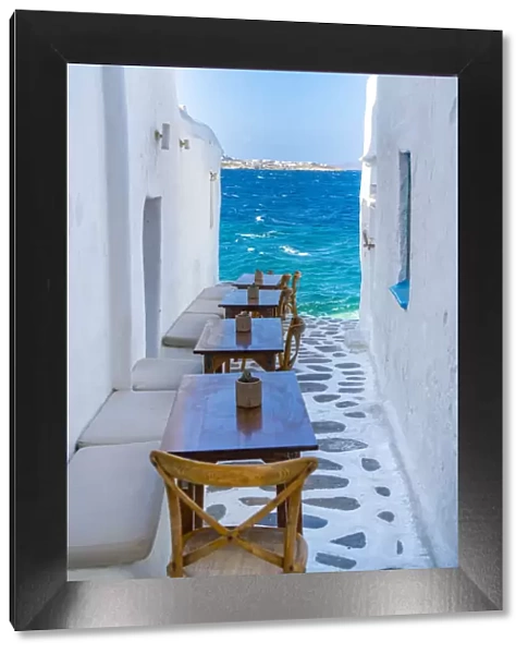 View of sea and restaurant tables in Mykonos Town, Mykonos, Cyclades Islands