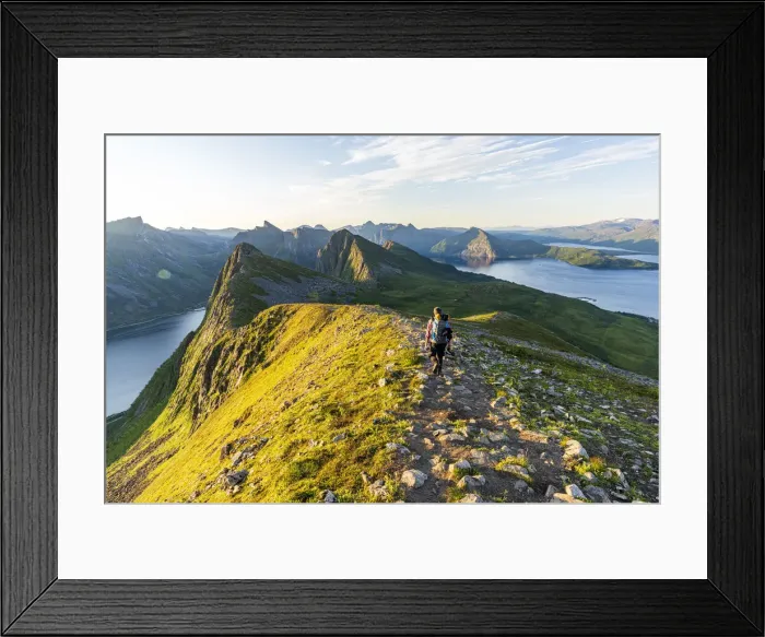 Framed Print : Rear view of man walking on path to Husfjellet mountain peak at sunrise, Senja island Framed Print : Rear view of man walking on path to Husfjellet mountain peak at sunrise, Senja island