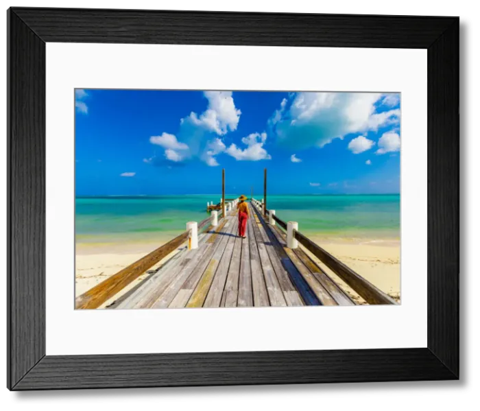 Framed Print : Woman walking up the pier that stretches out into the ocean from Horse Stable Beach Framed Print : Woman walking up the pier that stretches out into the ocean from Horse Stable Beach