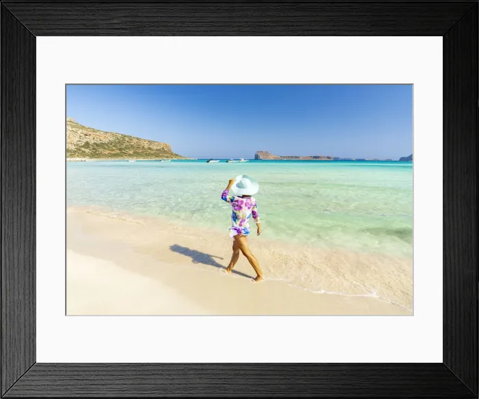 Framed Print : Beautiful woman with sun hat walking on idyllic empty beach, Crete, Greek Islands, Greece Framed Print : Beautiful woman with sun hat walking on idyllic empty beach, Crete, Greek Islands, Greece