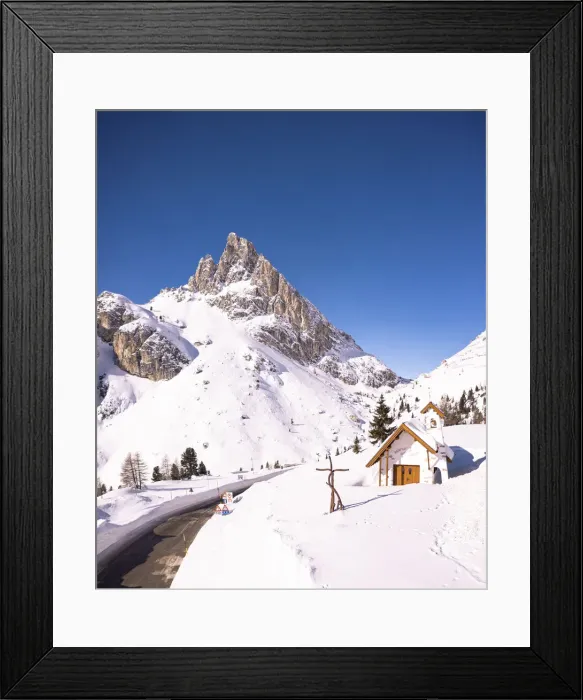 Framed Print : Alpine chapel in the snowy landscape with Sass de Stria peak in the background