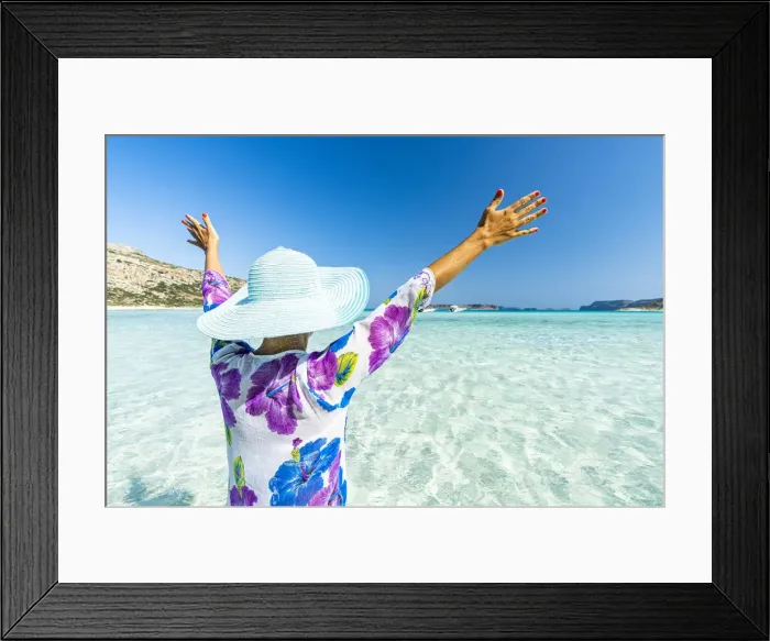 Framed Print : Cheerful woman with arms raised sunbathing in the clear sea, Crete, Greek Islands, Greece Framed Print : Cheerful woman with arms raised sunbathing in the clear sea, Crete, Greek Islands, Greece