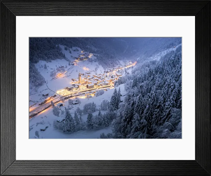 Framed Print : Trees covered with snow in the winter forest surrounding the alpine village at Christmas Framed Print : Trees covered with snow in the winter forest surrounding the alpine village at Christmas