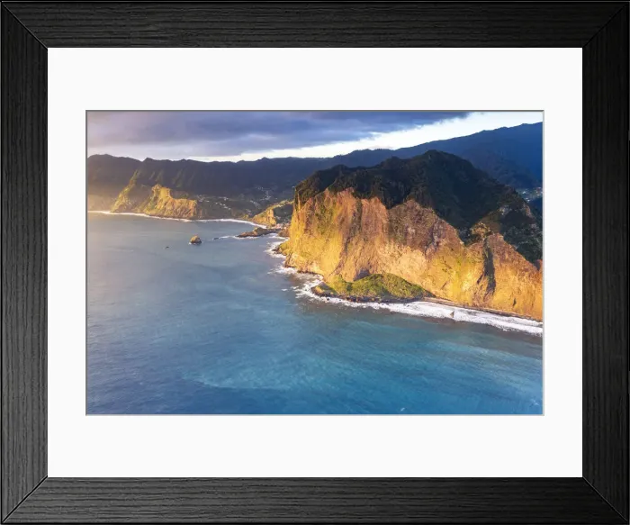 Framed Print : Aerial view of majestic cliffs and coastline at sunrise from Guindaste viewpoint, Faial Framed Print : Aerial view of majestic cliffs and coastline at sunrise from Guindaste viewpoint, Faial