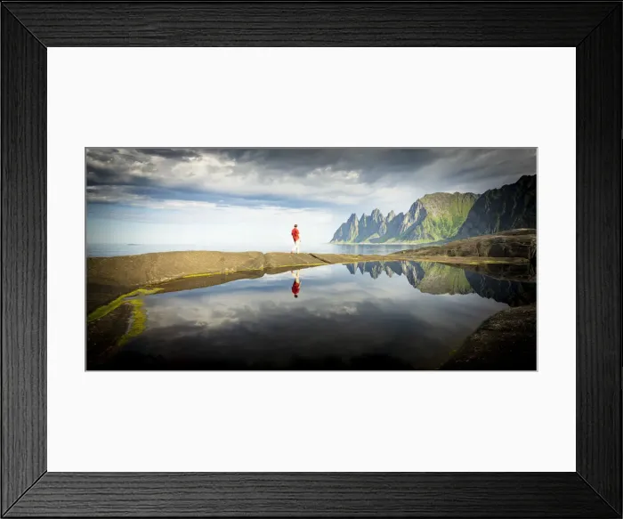 Framed Print : Hiker man walking on waters edge admiring mountains reflected in the sea, Tungeneset Framed Print : Hiker man walking on waters edge admiring mountains reflected in the sea, Tungeneset