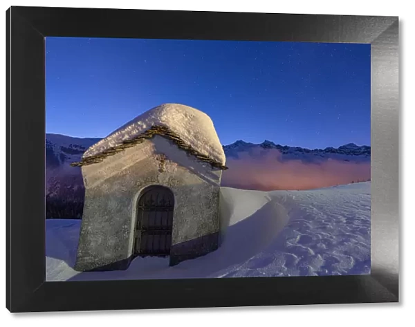 Small chapel covered with snow in the starry winter night, Andossi, Madesimo