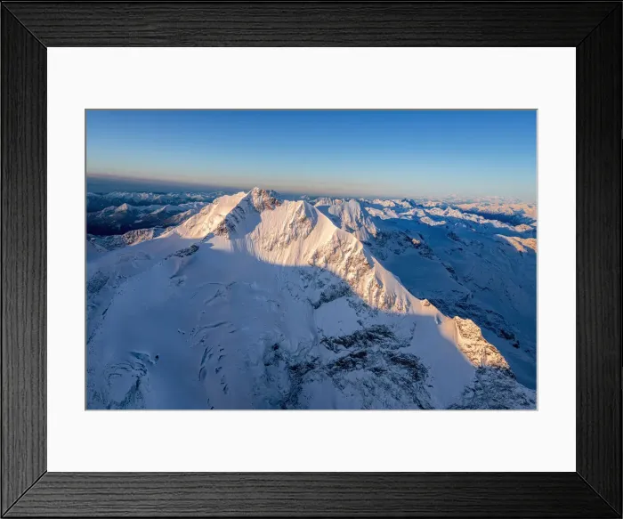 Framed Print : Aerial view of the snow covered Piz Bernina and Biancograt mountains at dawn, Engadine