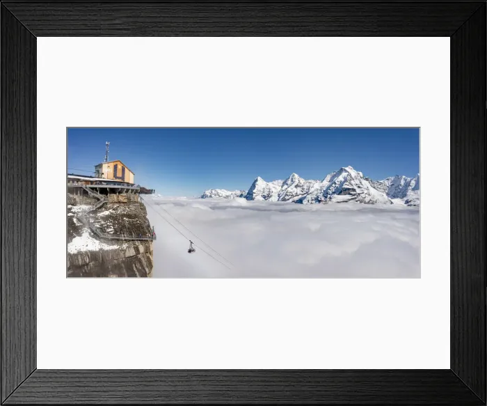 Framed Print : Aerial view of cable car in fog with Eiger, Monch, Jungfrau peaks in the background Framed Print : Aerial view of cable car in fog with Eiger, Monch, Jungfrau peaks in the background