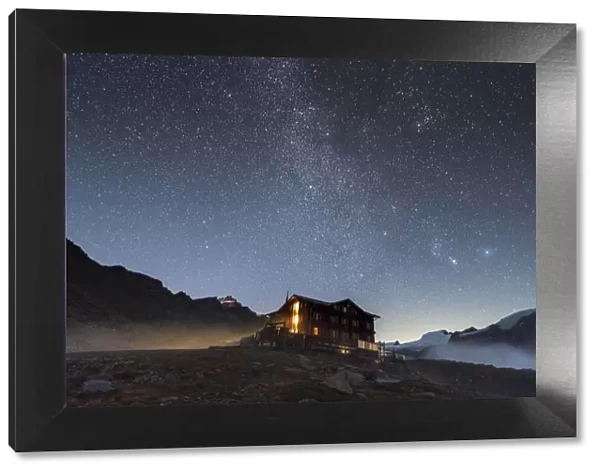 Illuminated mountain hut hotel under the stars, Fluhalp, Zermatt, Valais Canton