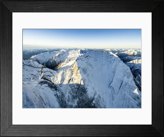 Framed Print : Aerial vew of majestic rocks of the snowcapped Pizzo Badile in winter, Val Bregaglia Framed Print : Aerial vew of majestic rocks of the snowcapped Pizzo Badile in winter, Val Bregaglia
