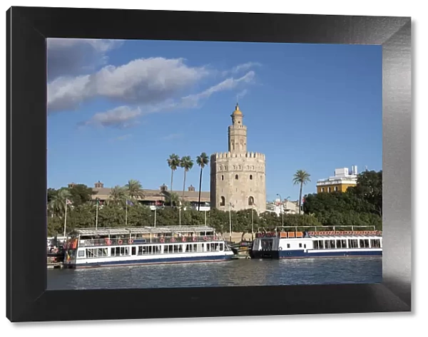 Tourist boats in front of the Torre del Oro (Gold Tower) in Seville, Andalucia, Spain