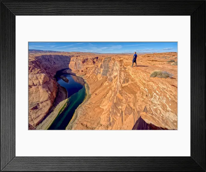 Framed Print : A man hiking on the edge of a cliff overlooking Horseshoe Bend near Page, Arizona Framed Print : A man hiking on the edge of a cliff overlooking Horseshoe Bend near Page, Arizona