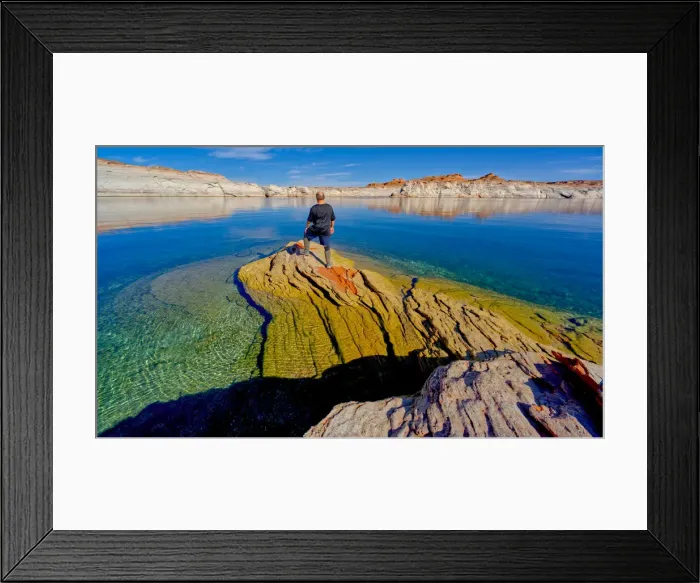 Framed Print : A hiker standing on a rock peninsula at Lake Powell, Arizona, United States of America