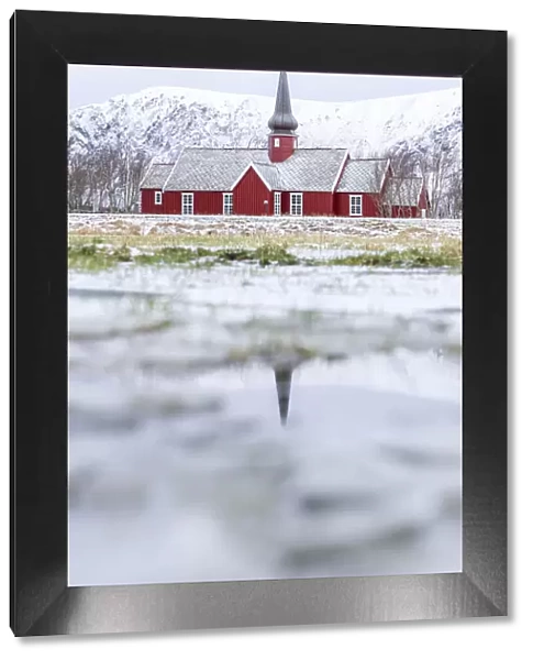 Church of Flakstad reflected in a pond in winter, Nordland county, Lofoten Islands, Norway, Scandinavia, Europe