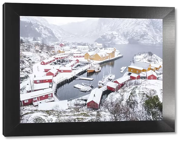 High angle view of traditional fishermens cabins and harbor covered with snow, Nusfjord, Nordland, Lofoten Islands, Norway, Scandinavia, Europe
