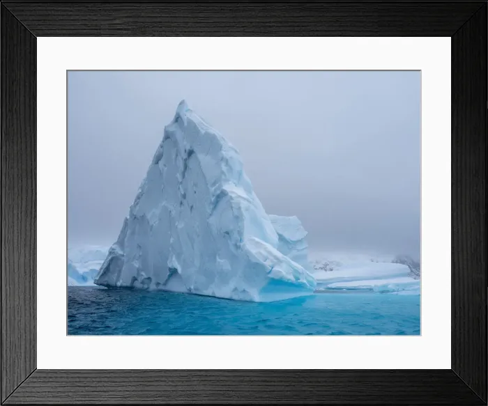 Framed Print : A huge iceberg grounded on a reef near the Iceberg Graveyard, Petermann Island, Antarctica, Polar Regions