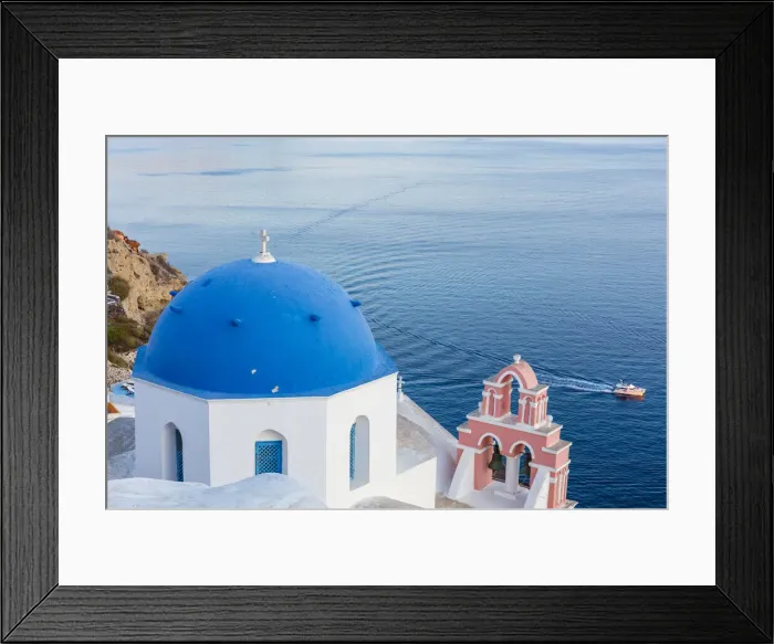 Framed Print : Blue domed white church overlooking boat in Aegean Sea, Santorini, Cyclades, Greek Islands, Greece, Europe Framed Print : Blue domed white church overlooking boat in Aegean Sea, Santorini, Cyclades, Greek Islands, Greece, Europe