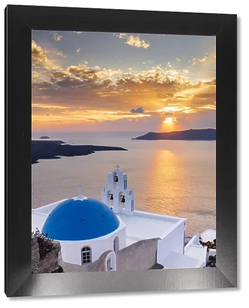 A white church with blue dome overlooking the Aegean Sea at sunset, Santorini, Cyclades, Greek Islands, Greece, Europe