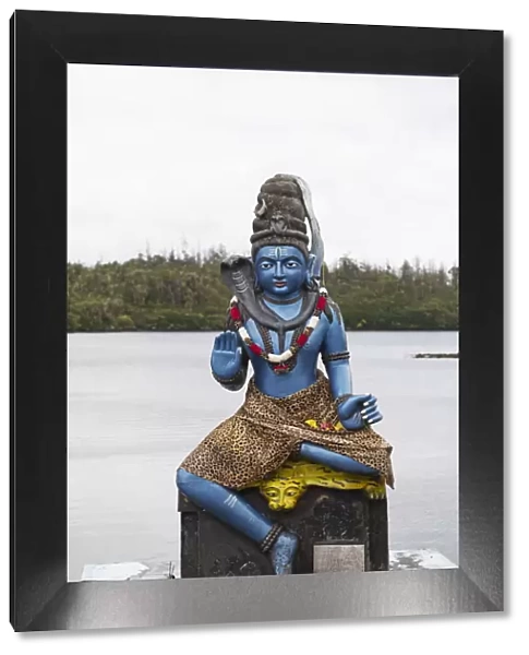 Statue of Vishnu, the Hindu god with cobra and wearing a leopardskin, in human form as Krishna, at Ganga Talao, Mauritius, Indian Ocean, Africa