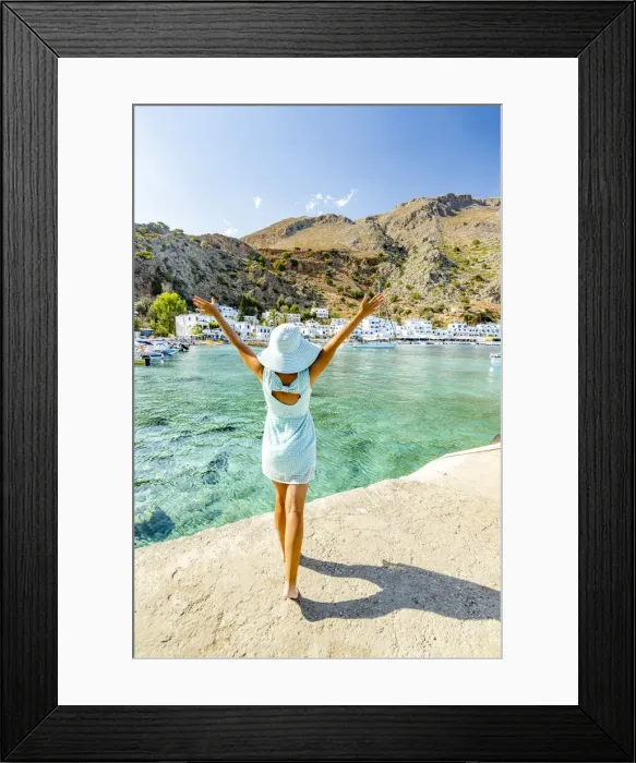 Framed Print : Cheerful woman with sun hat admiring the village of Loutro and crystal sea, Crete island, Greek Islands, Greece, Europe Framed Print : Cheerful woman with sun hat admiring the village of Loutro and crystal sea, Crete island, Greek Islands, Greece, Europe
