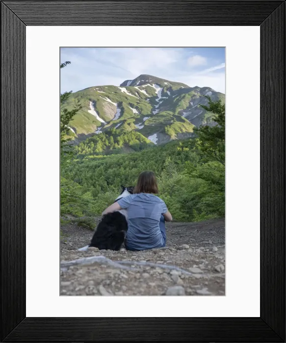Framed Print : A girl sitting beside and hugging her border collie dog staring at a mountain landscape of Cusna Mountain, Emilia Romagna, Italy, Europe Framed Print : A girl sitting beside and hugging her border collie dog staring at a mountain landscape of Cusna Mountain, Emilia Romagna, Italy, Europe