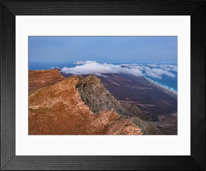 Framed Print : Aerial view of volcanic rocks of Pico de la Zarza mountain peak during a misty sunrise, Fuerteventura, Canary Islands, Spain, Atlantic, Europe Framed Print : Aerial view of volcanic rocks of Pico de la Zarza mountain peak during a misty sunrise, Fuerteventura, Canary Islands, Spain, Atlantic, Europe