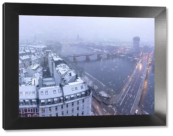Aerial view of traditional houses and bridges along River Main during a snow storm in winter, Frankfurt, Hesse, Germany Europe