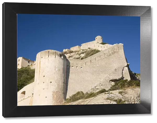 Low angle view of the massive stone walls and defensive towers of the citadel, Bonifacio, Corse-du-Sud, Corsica, France, Mediterranean, Europe