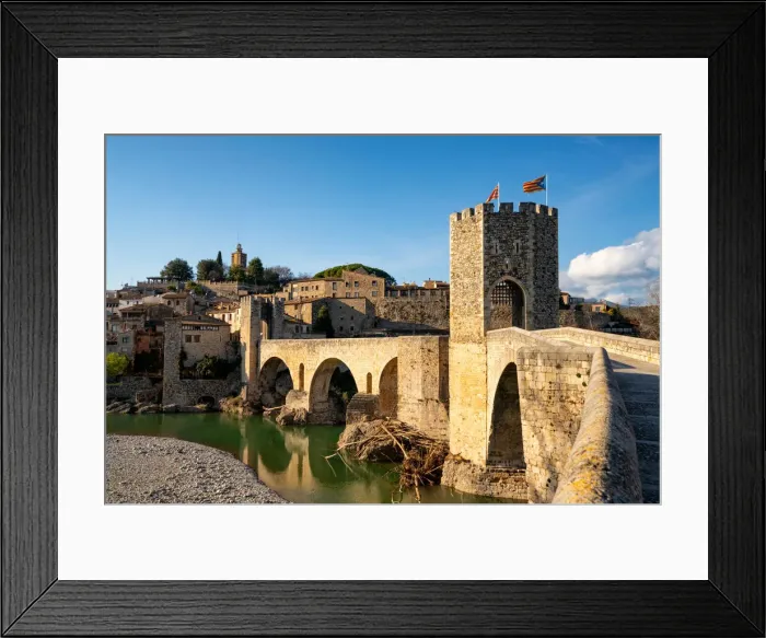 Framed Print : Besalu historic medieval city with Catalonia flags on the stone bridge tower crossing El Fluvia river, Besalu, Catalonia, Spain, Europe Framed Print : Besalu historic medieval city with Catalonia flags on the stone bridge tower crossing El Fluvia river, Besalu, Catalonia, Spain, Europe