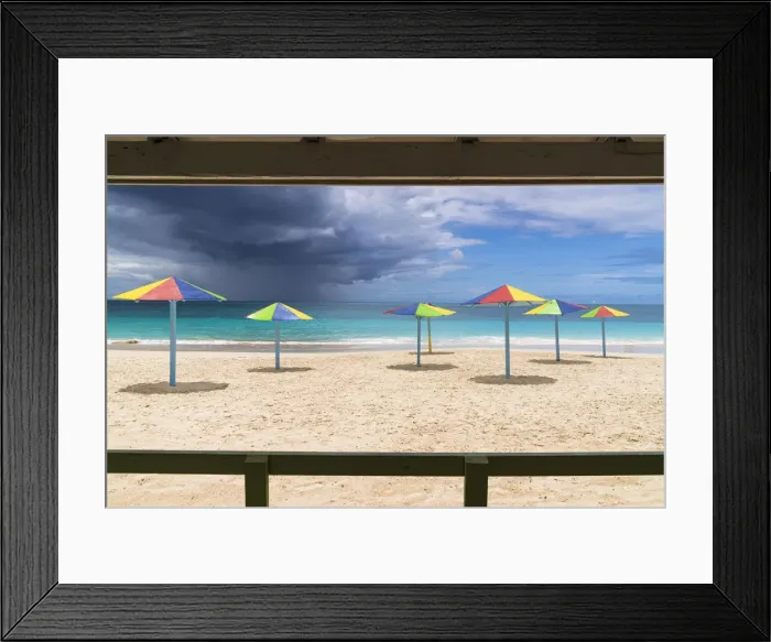 Framed Print : Multicolored striped umbrellas on white sand beach under storm clouds, Antigua, West Indies, Caribbean, Central America Framed Print : Multicolored striped umbrellas on white sand beach under storm clouds, Antigua, West Indies, Caribbean, Central America