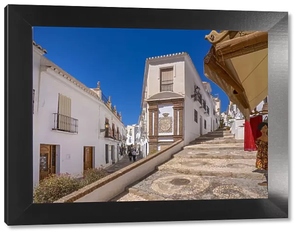 View of whitewashed houses and clothes shop on narrow street, Frigiliana, Malaga Province, Andalucia, Spain, Mediterranean, Europe