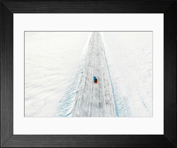 Framed Print : Cold winter sun over an isolated car traveling on ice road on frozen sea, aerial view, Lulea, Norrbotten County, Lapland, Sweden Framed Print : Cold winter sun over an isolated car traveling on ice road on frozen sea, aerial view, Lulea, Norrbotten County, Lapland, Sweden