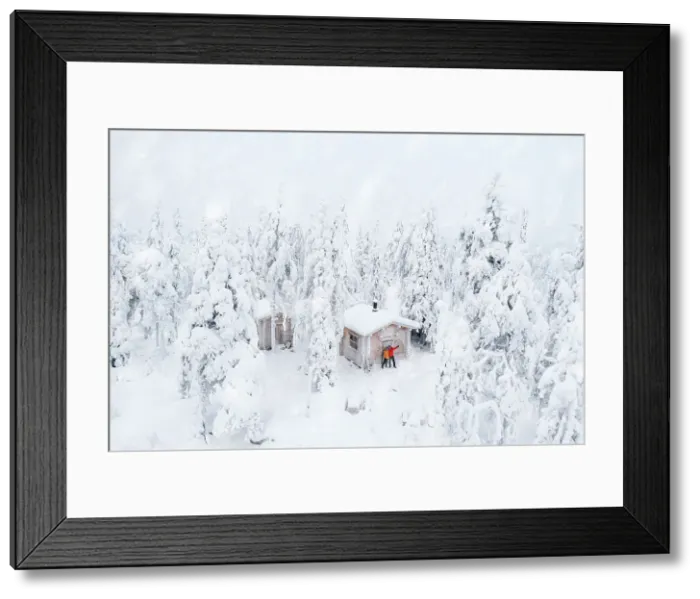 Framed Print : Aerial view of happy couple enjoying the winter holidays in a frozen hut in the snowy forest, Iso Syote, Northern Ostrobothnia, Lapland, Finland, Europe Framed Print : Aerial view of happy couple enjoying the winter holidays in a frozen hut in the snowy forest, Iso Syote, Northern Ostrobothnia, Lapland, Finland, Europe