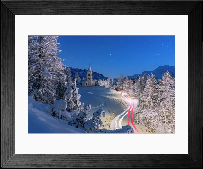 Framed Print : Car trails lights on snowy mountain road leading to Chiesa Bianca under the stars, Maloja, Engadine, Canton of Graubunden, Switzerland, Europe